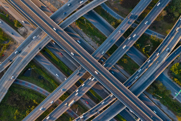 istock Aerial view of highway junctions with roundabout. Bridge roads shape circle in structure of architecture and transportation concept. Top view. Urban city, Bangkok at sunset, Thailand. 1343083812
