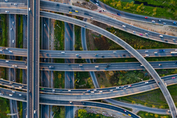 istock Aerial view of highway junctions with roundabout. Bridge roads shape circle in structure of architecture and transportation concept. Top view. Urban city, Bangkok at sunset, Thailand. 1343083816