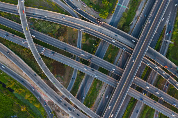 istock Aerial view of highway junctions with roundabout. Bridge roads shape circle in structure of architecture and transportation concept. Top view. Urban city, Bangkok at sunset, Thailand. 1343083819