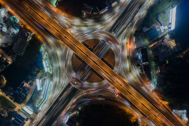 istock Aerial view of highway junctions with roundabout. Bridge roads shape circle in structure of architecture and transportation concept. Top view. Urban city, Bangkok at sunset, Thailand. 1343084120