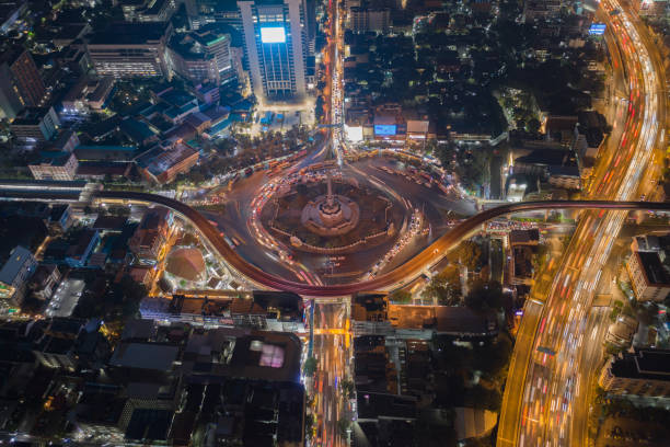 istock Aerial view of highway junctions with roundabout. Bridge roads shape circle in structure of architecture and transportation concept. Top view. Urban city, Bangkok at sunset, Thailand. 1343085776