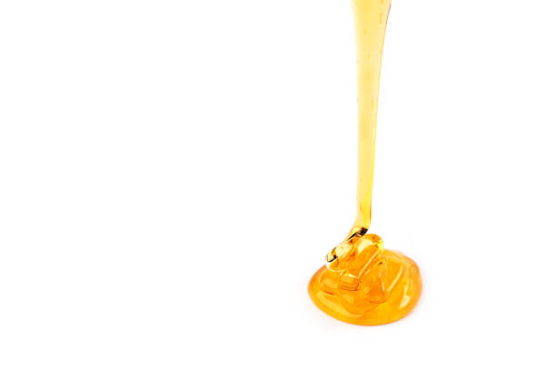 istock Pouring honey isolated on white background. 1343087710