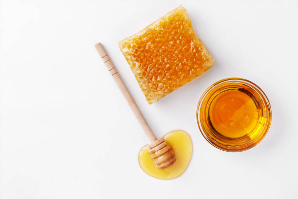 istock Sweet honey and honeycomb top view on white background. 1343087712