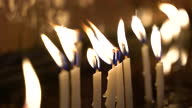 istock 4k video footage of burning candles in a church, Close up view 1343088885