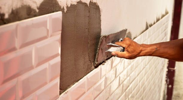 istock House renovation, Laying ceramic tles on the wall. 1343089788
