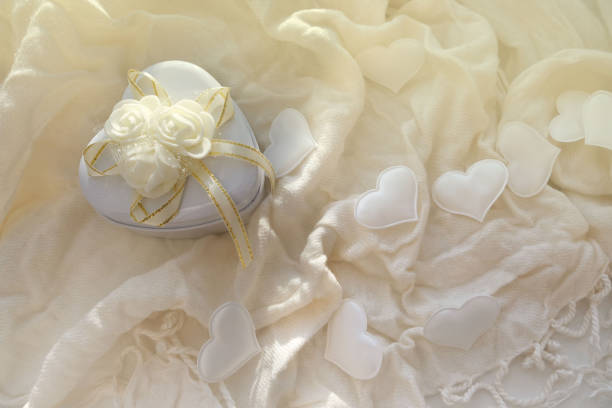 istock White hearts anad gift box on  delicate soft background.  Valentine's celebration, romantic concept. copy space.  Hygge Style. 1343090628