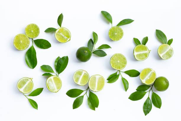 istock Fresh limes with green leaves on white background. 1343090874