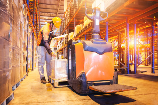 istock Warehouse Worker Doing Inventory Management at Storage Warehouse. Check Stock Tall Shelves Shipping Warehouse Logistics 1343098652