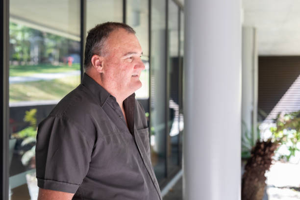 istock Casually Dressed Overweight Businessman Outside an Office Building 1343098757