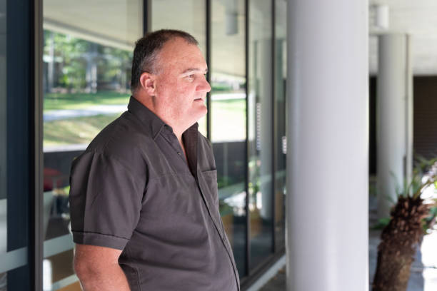 istock Casually Dressed Overweight Businessman Outside an Office Building 1343098773