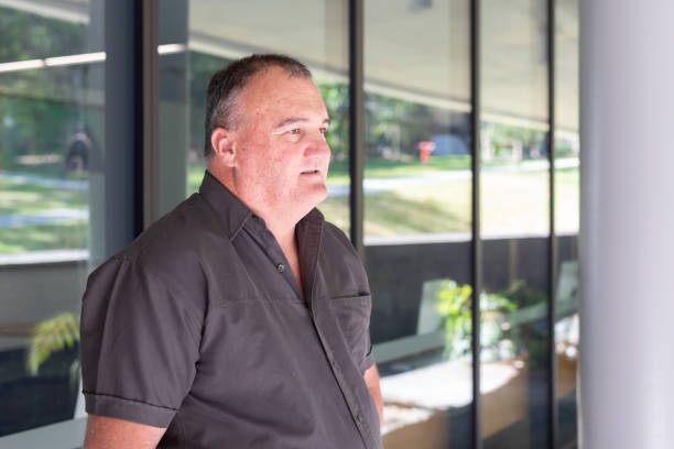 istock Casually Dressed Overweight Businessman Outside an Office Building 1343098774