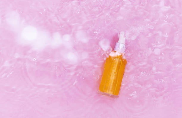 istock Serum bottle texture water pink background 1343099590