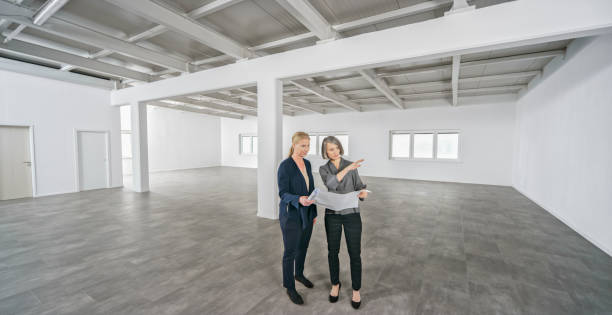 istock Businesswomen discussing blueprint 1343100823