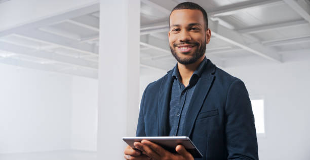 istock Businessman standing with digital tablet in office 1343100859