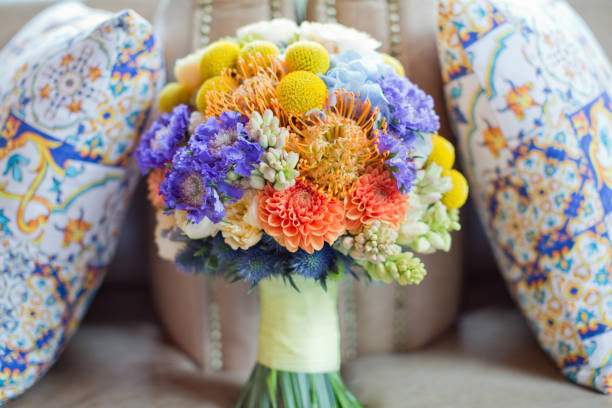 Bright colorful italy wedding bouquet with orange,yellow, white and blue flowers. Sicily wedding concept