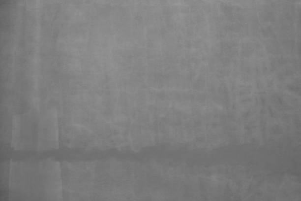Porous rough  dark gray painted wall background-  Grunge background