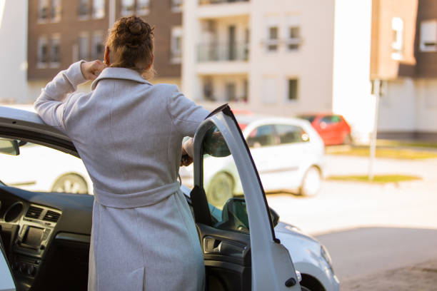 istock Standing in the car door and contemplating while waiting for a driver 1343102178