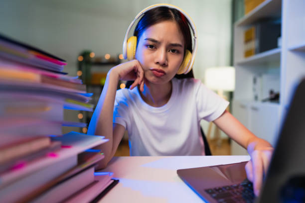 istock Boring young woman wearing headset and hand typing on keyboard with document file on the table, working on computer, do the same job every day. 1343102299