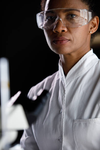 istock Female lab tech in protective eyewear looking at camera 1343102587