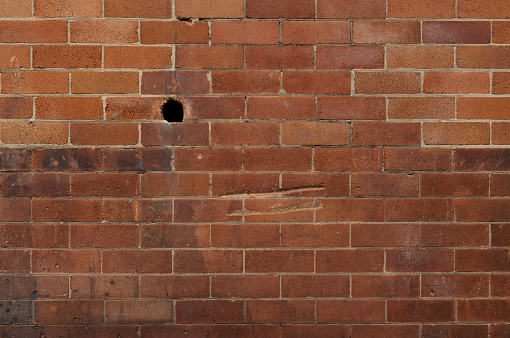 Brick wall with a hole.