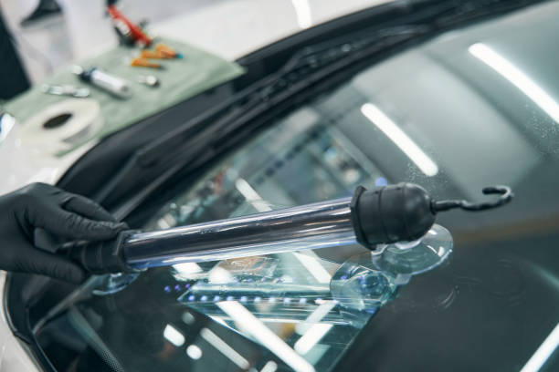 istock Repair cracked car windshield. Ultraviolet lamp for final elimination 1343117554