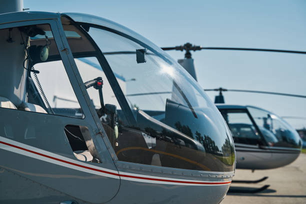 istock Modern civilian helicopters parked on concrete helipad 1343120892