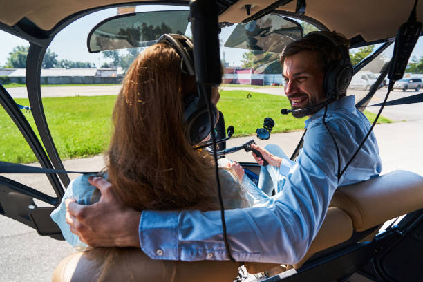 istock Cheerful airman comforting woman passenger before helicopter flight 1343120932