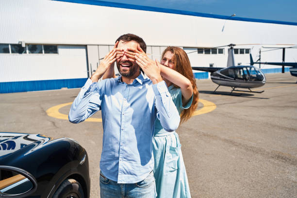 istock Woman preparing man for surprise on helipad 1343120934