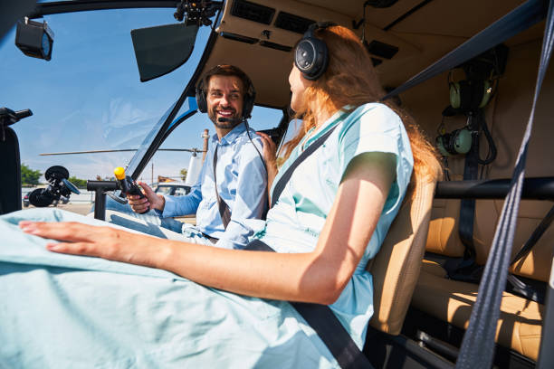 istock Happy airman smiling at female passenger before take-off 1343120935