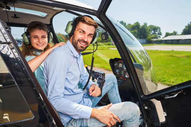 istock Happy young couple sitting in private chopper 1343120974