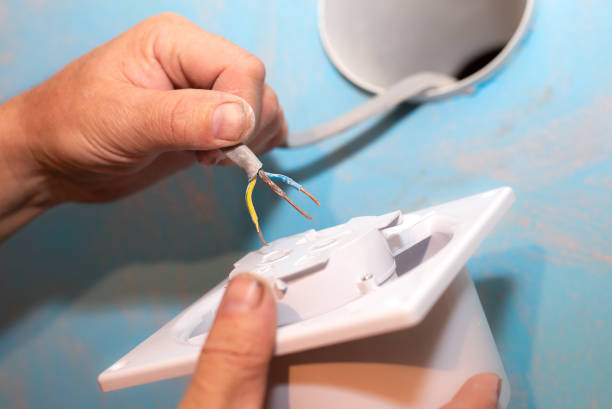 istock Man is installing the wall bathroom fan vent. Restoration process. Wires in hands. Maintenance repair works renovation in the flat. 1343128423