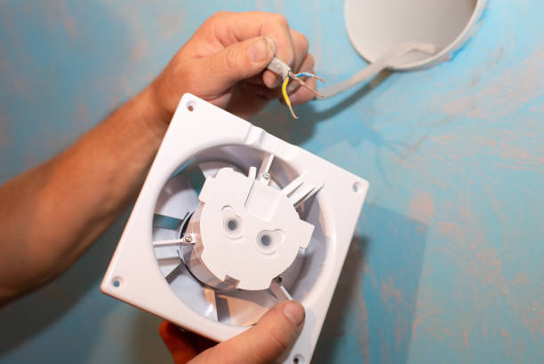 istock Man is installing the wall bathroom fan vent. Restoration process. Wires in hands. Maintenance repair works renovation in the flat. 1343128442