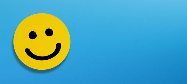 istock Happy smiley face emoticon with copy space on blue background 1343130267