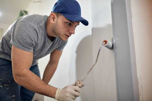 Young adult man painting on a DIY budget renovation of his new home apartment. Young adult man painting on a DIY budget renovation of his new home apartment. hobbyist stock pictures, royalty-free photos & images