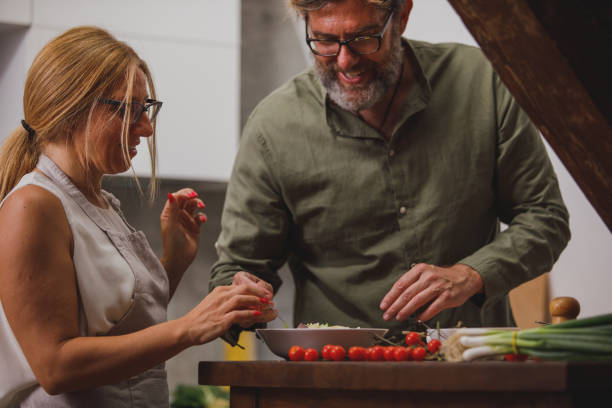 istock Happy mature couple having bonding moments while making dinner together 1343139368