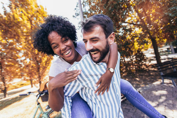istock Handsome man giving piggy back to his girlfriend. 1343141568