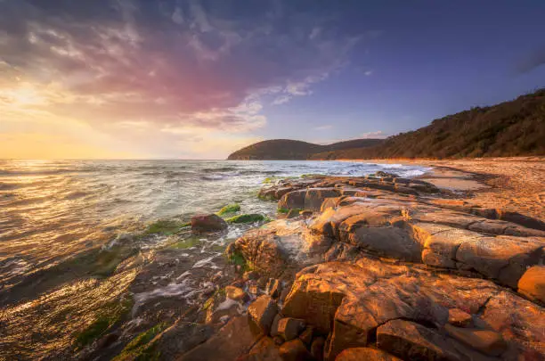 Photo of Sunset in Cala Violina bay beach in Maremma, Tuscany. Mediterranean sea. Italy.