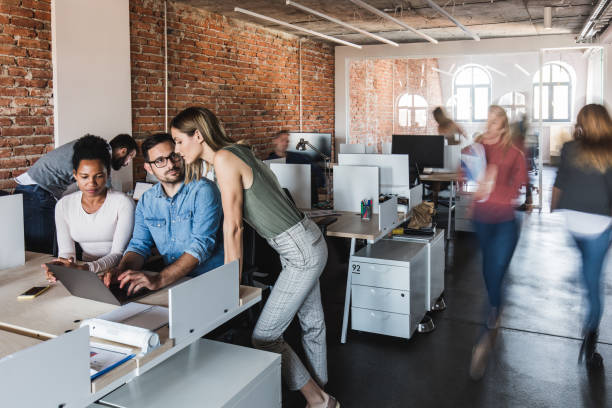 istock Working on laptop at busy corporate office! 1343149918