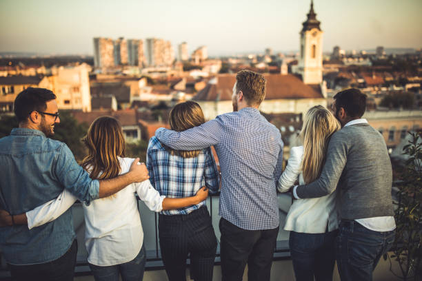 istock Back view of embraced couples looking at view from a terrace. 1343150127