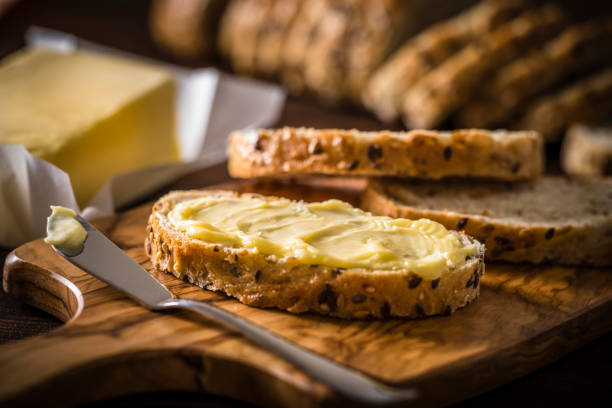 istock Slice of bread spread with butter 1343150514