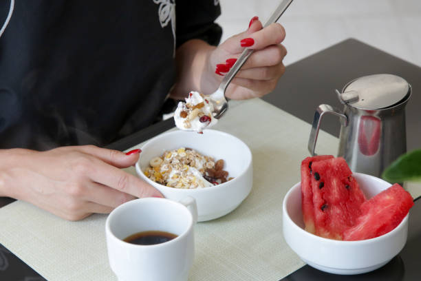 istock Young woman having breakfast in restaurant 1343151298