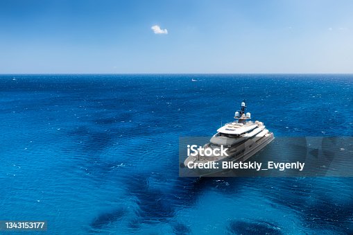 istock Aerial view of the ship from drone. Blue clear water in the Mediterranean Sea. Summer vacation and travel on a cruise liner. Summer trip. 1343153177