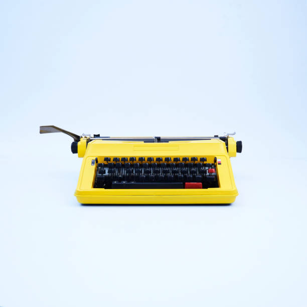 Typewriter Yellow vintage typewriter high angle shot, front side view typewriter writing retro revival work tool stock pictures, royalty-free photos & images