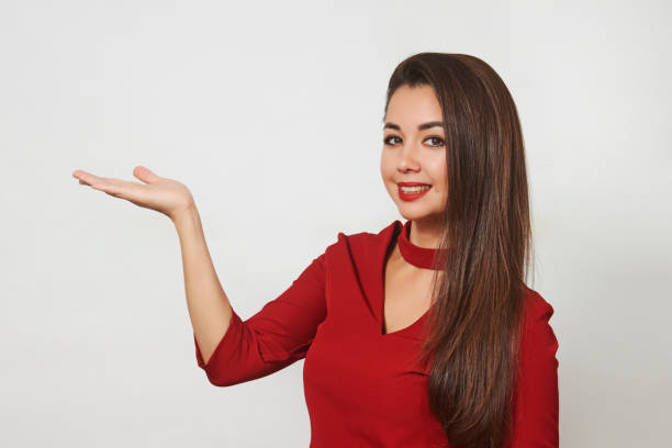 istock Young woman showing welcome gesture, close-up 1343153298