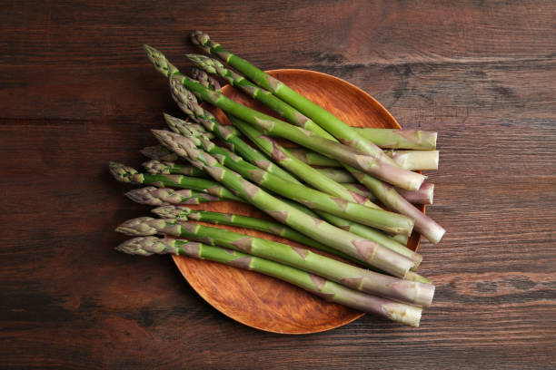 istock Fresh raw asparagus on wooden table, top view 1343159511