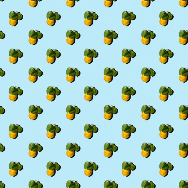 Ripe juicy yellow pears with green leaves on a colored background. Seamless patterns.