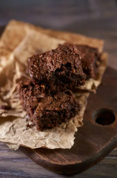 Freshly baked chocolate brownies on a wooden background