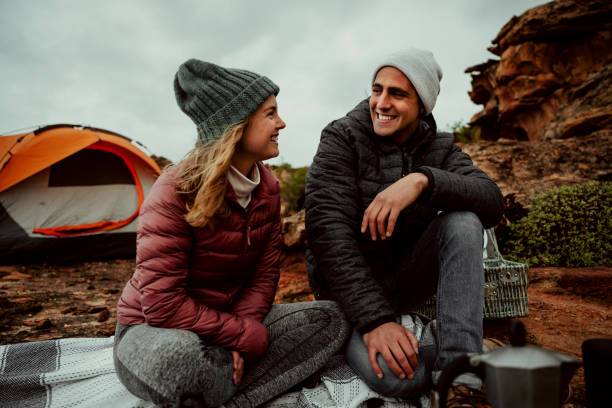 istock Caucasian romantic couple chatting while camping outside in the mountain smiling 1343168789