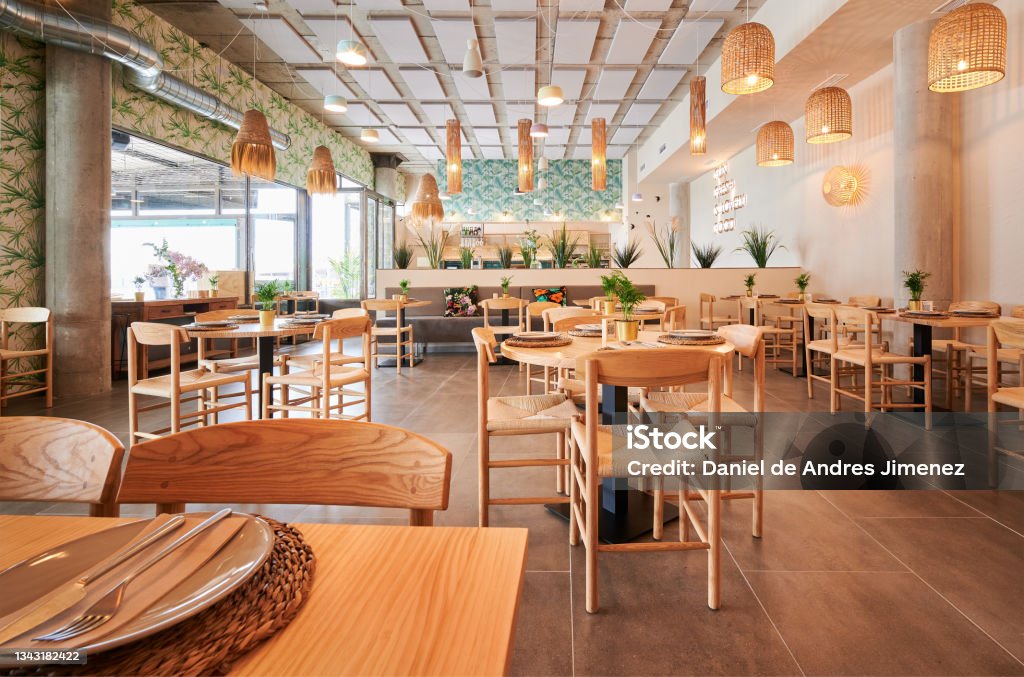 empty rustic design restaurant with wooden furniture and some decorative plants Restaurant Stock Photo