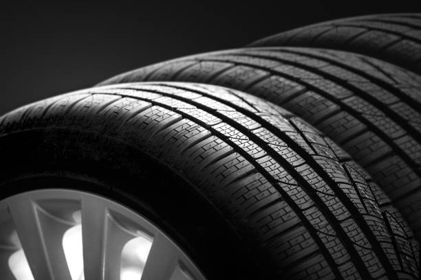 istock Car tire and rim on black background 1343185208